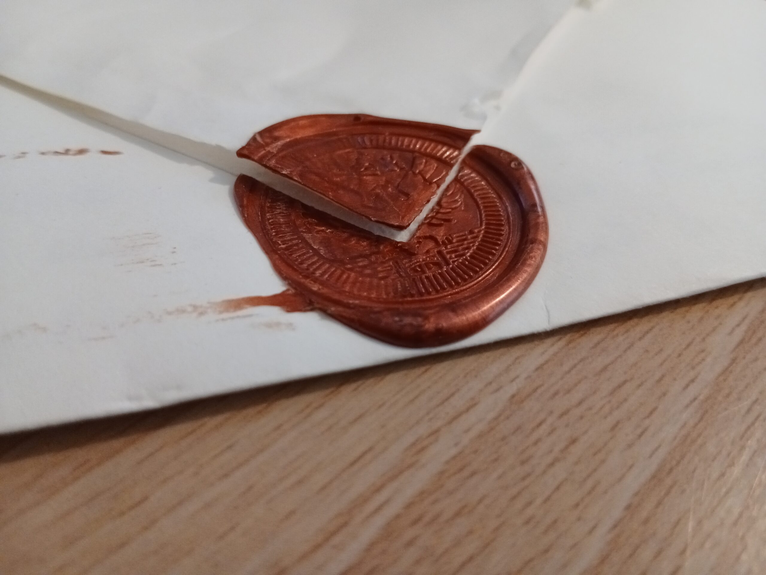 An image of a broken seal on a letter